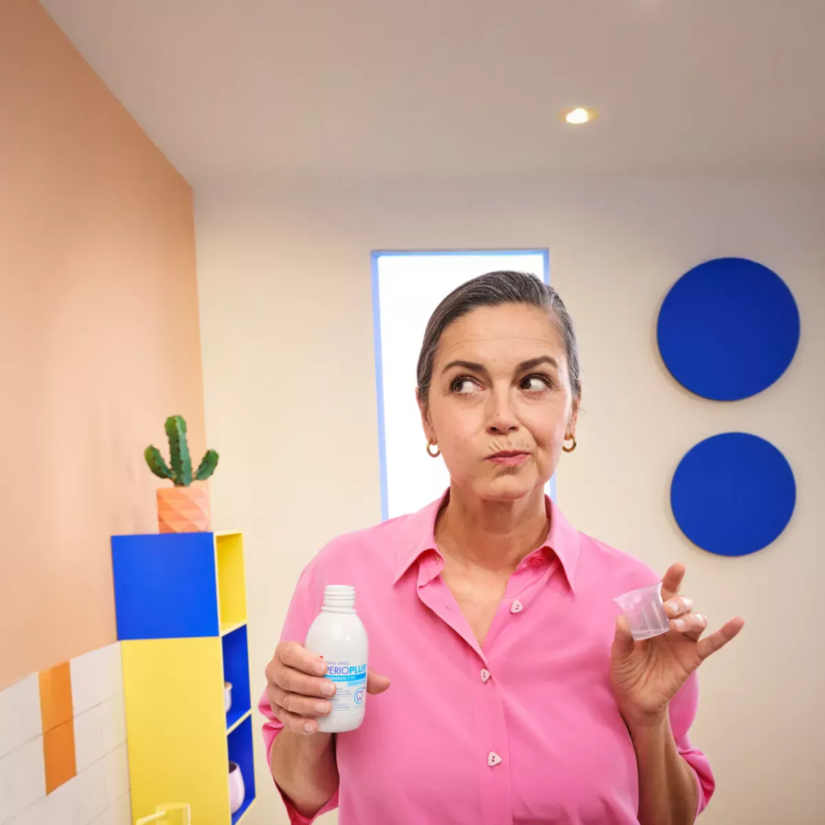 Woman using mouthwash