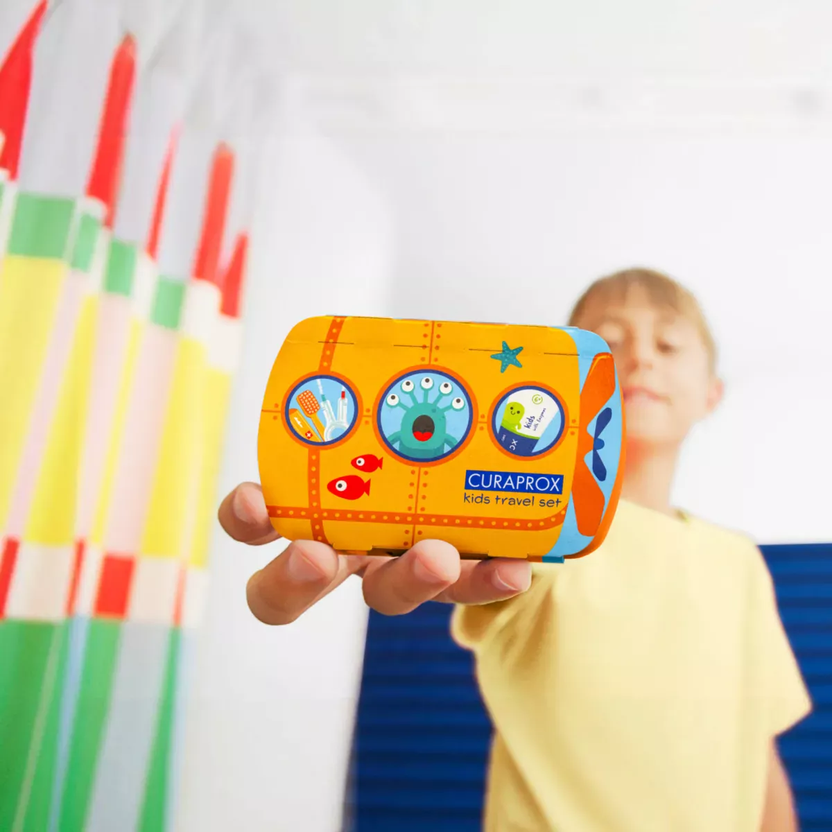 Child holding travel set