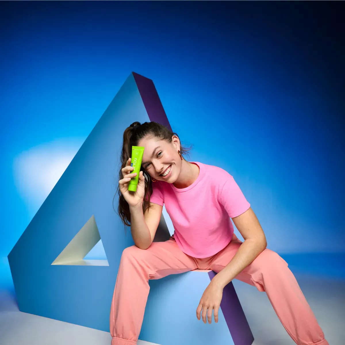 Smiling woman holding toothpaste