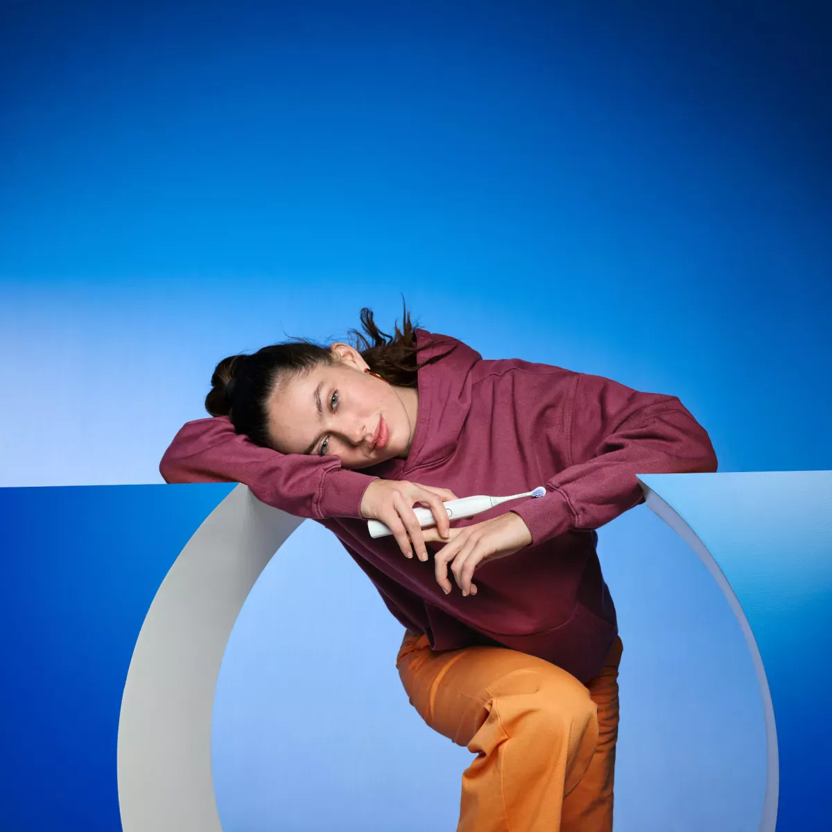 Woman holding electric toothbrush